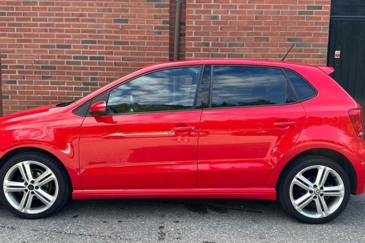 a car parked in front of a brick building