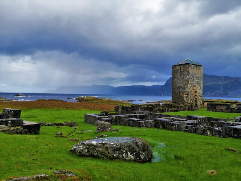 a castle on top of a lush green field